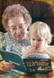 grandmother reading a story to her granddaughter